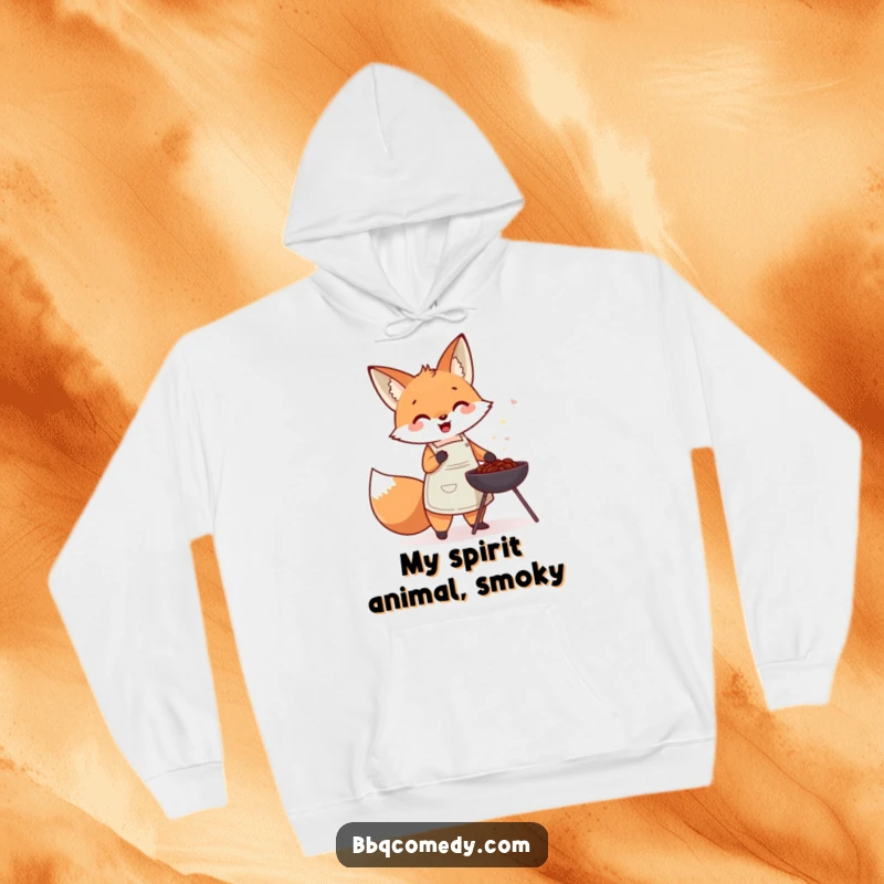 Cute fox in an apron gleefully fanning a small charcoal barbecue, designed for cozy wear.